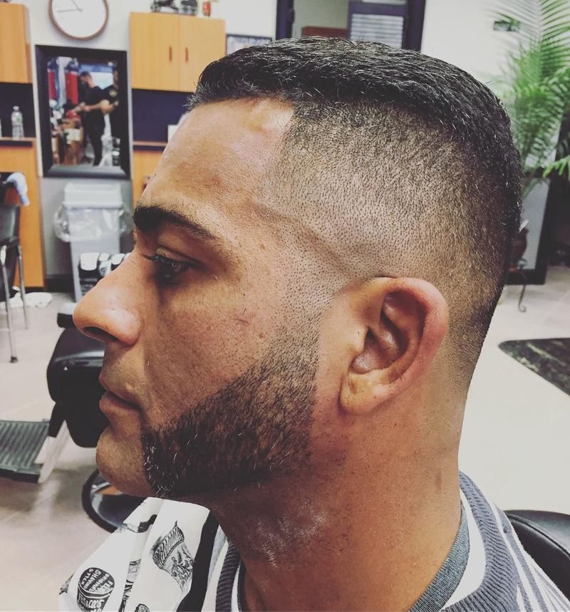 Skin fade with a lined-up beard.
